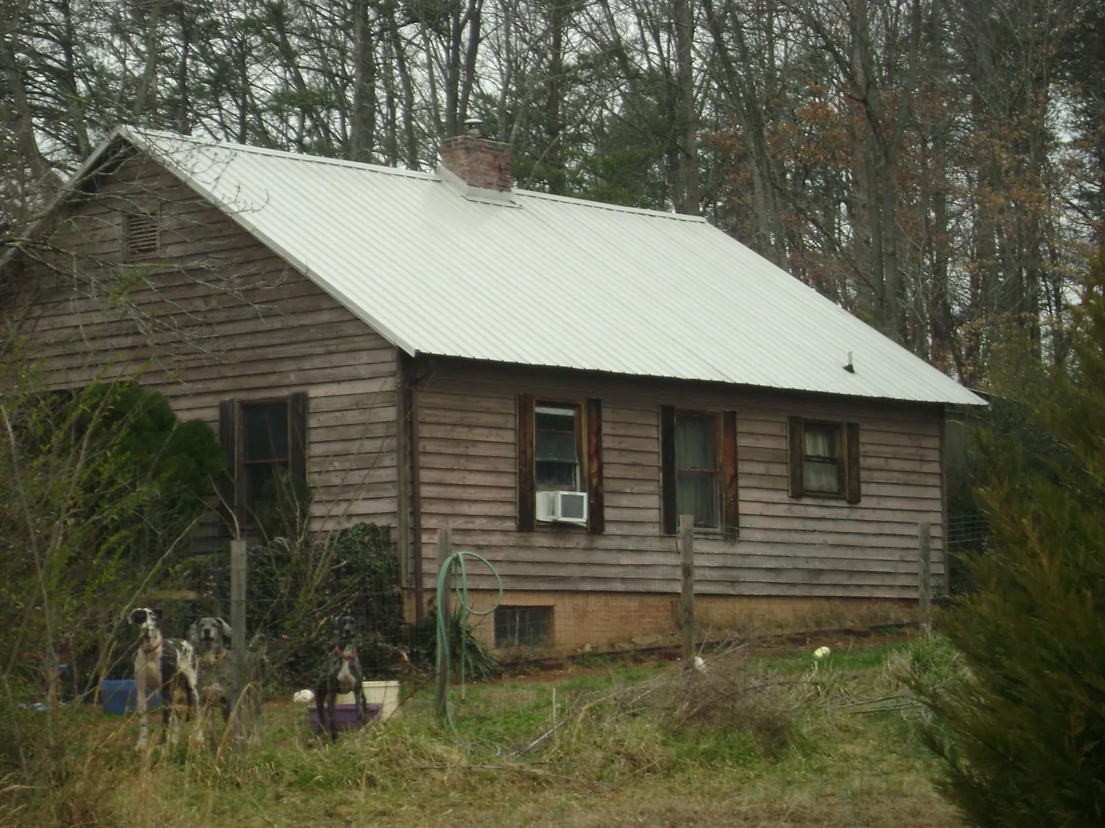 White metal roof on an old wood sided farmhouse, from a Metal Roof Installation job in Bennettsville